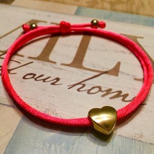 Red thread with Tibetan Heart charm